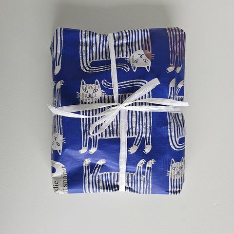 Present wrapped in «Puss in Boots» paper with a white ribbon