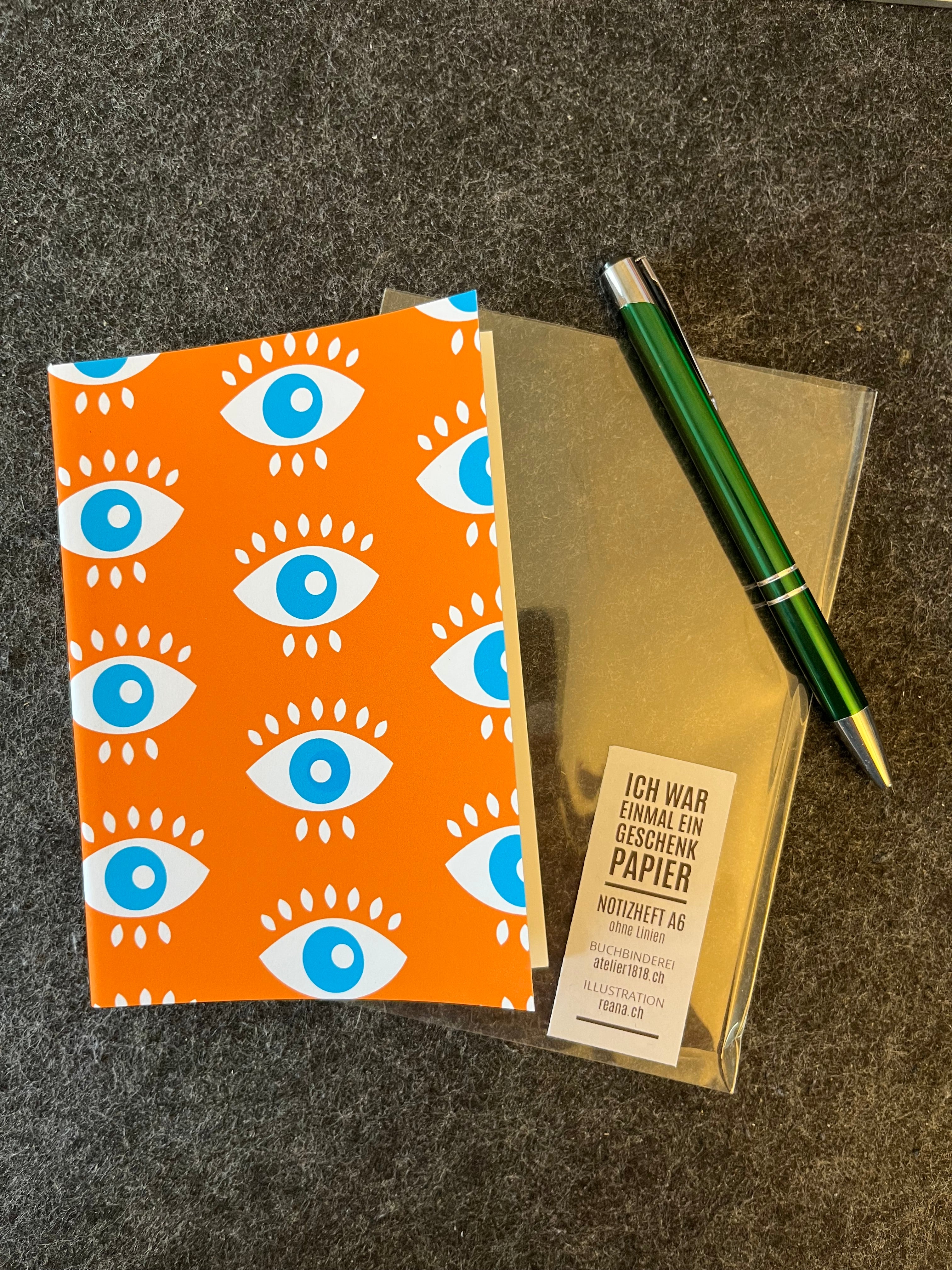 Notizheft Orange Augen A6 – All eyes on me