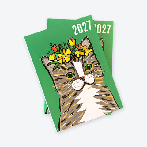Two Cat Sir James 2027 agendas stacked at an angle, with the thread binding visible on the spine