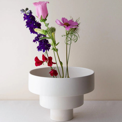 White three-tiered STACK bowl Large in earthenware, holding a few garden flowers in purple, pink and red